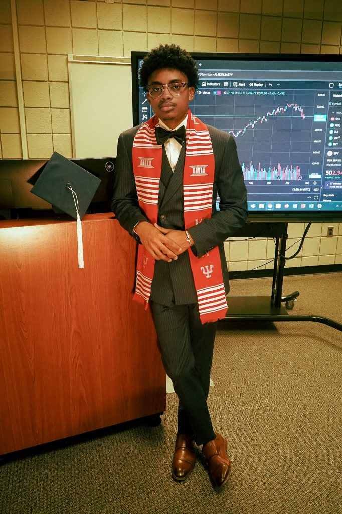 Byran McKinney wearing a red and white Kappa Alpha Psi fraternity graduation stole