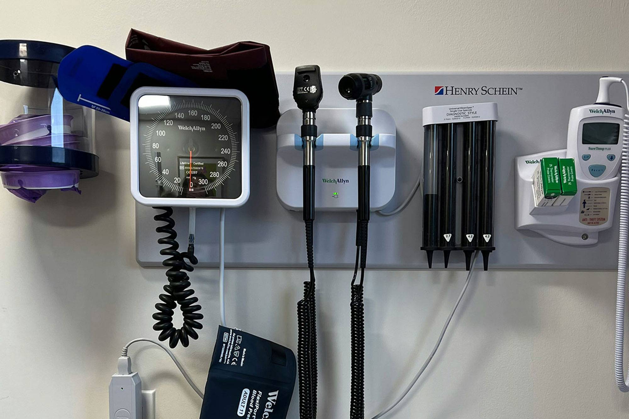 A row of doctor's office tools hanging on the wall